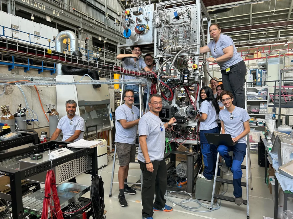 Part of the Acceleron Fusion and NK Labs team pose onsite at the High Intensity Proton Accelerator Facility at the Paul Scherrer Institute in Switzerland